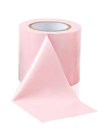 a roll of pink tape on a white background